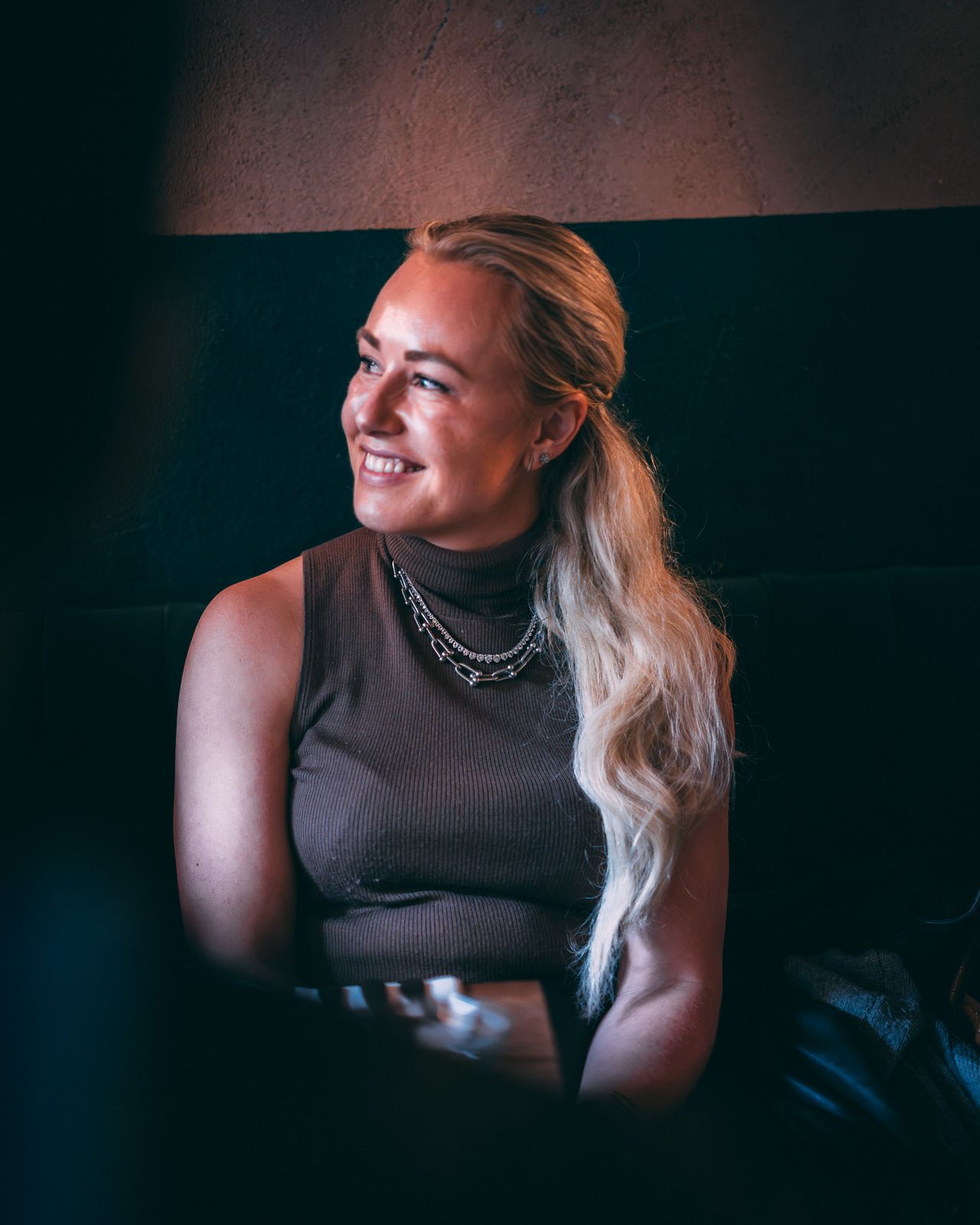 Guest smiling in warm evening light at a dinner event