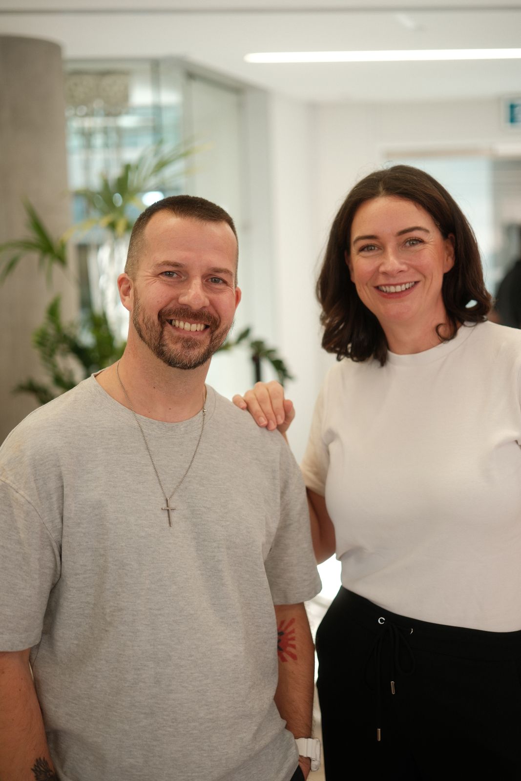 Two guests posing together at an office event