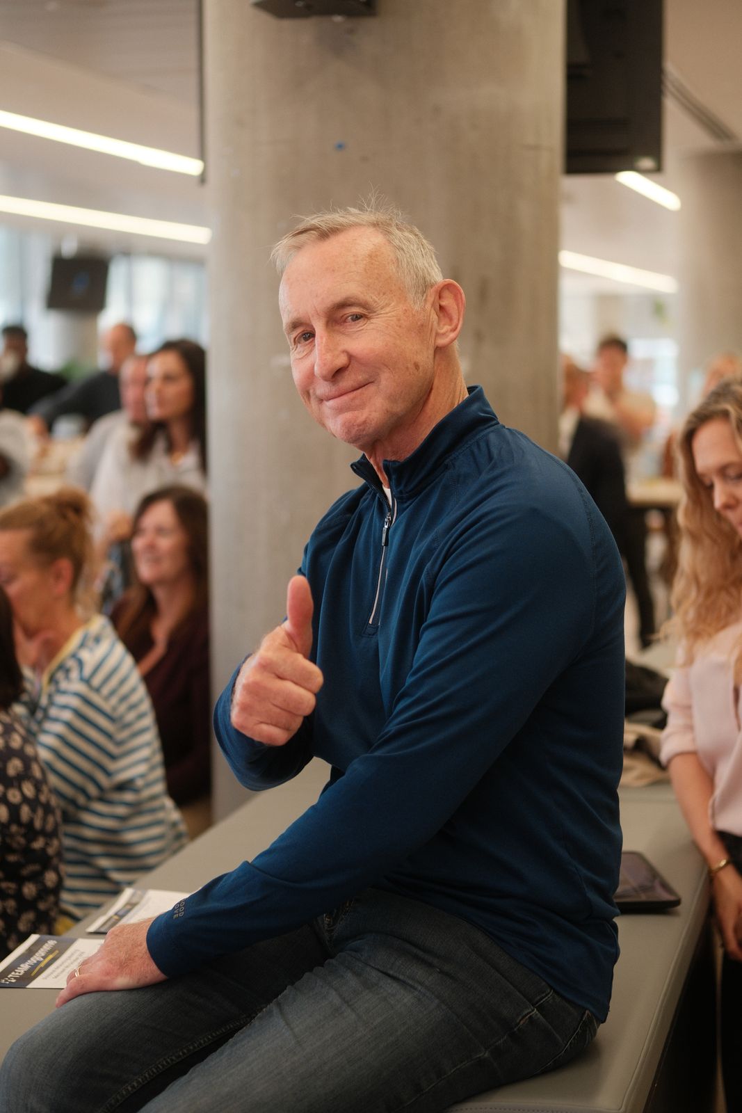 Attendee giving a thumbs up at a business event
