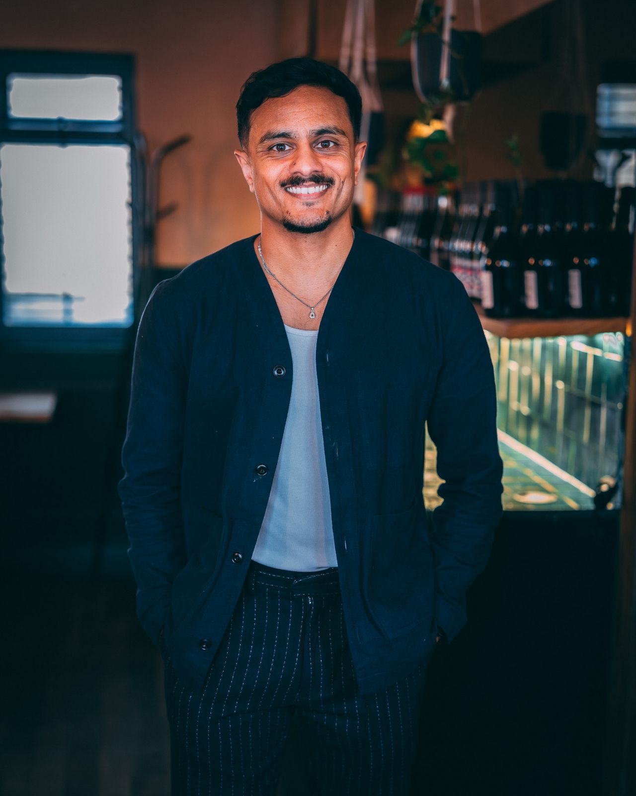 Portrait of a man in a navy suit in a restaurant