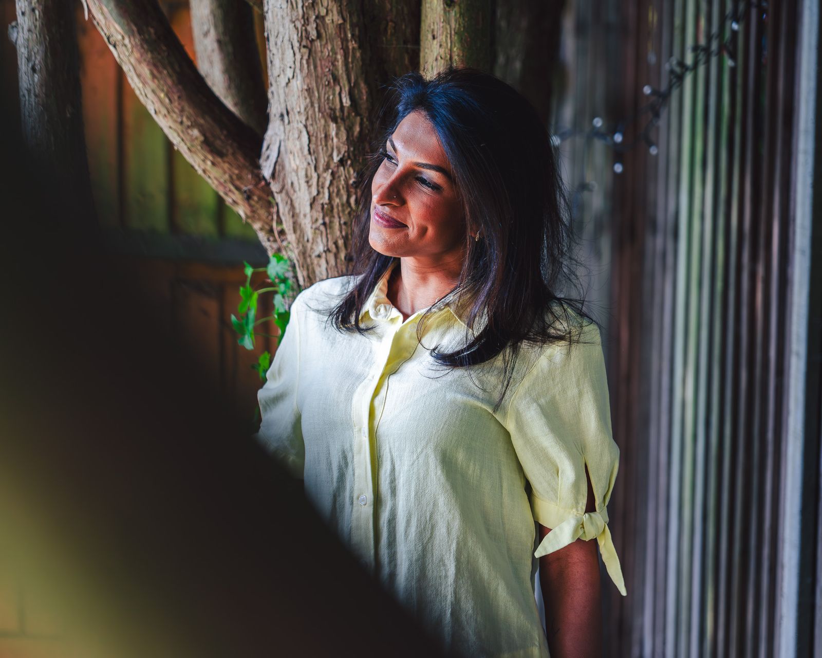 Portrait of a woman in a yellow shirt in soft natural light